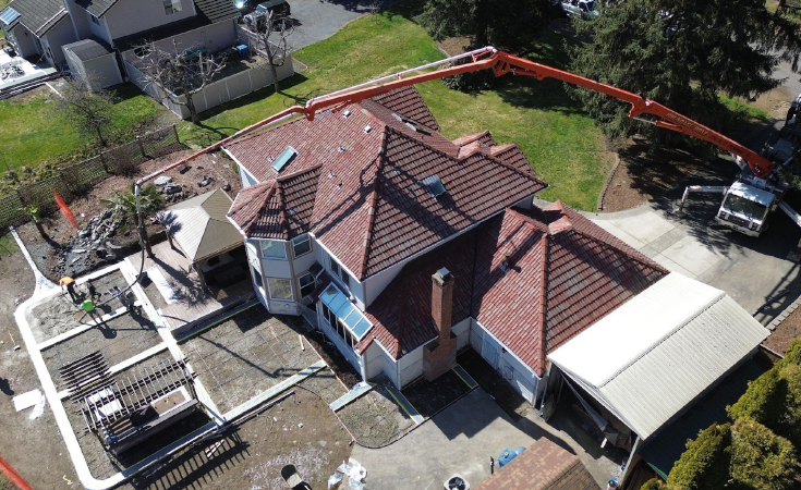 Aerial view of large backyard concrete patio in progress